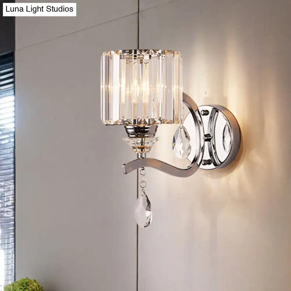 Modern chrome cylinder wall light featuring a sleek chrome finish and crystal block shade with teardrop crystals