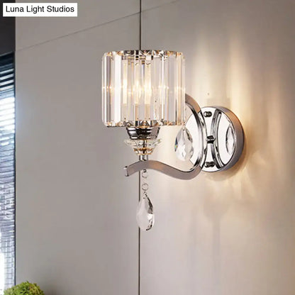 Modern chrome cylinder wall light featuring a sleek chrome finish and crystal block shade with teardrop crystals