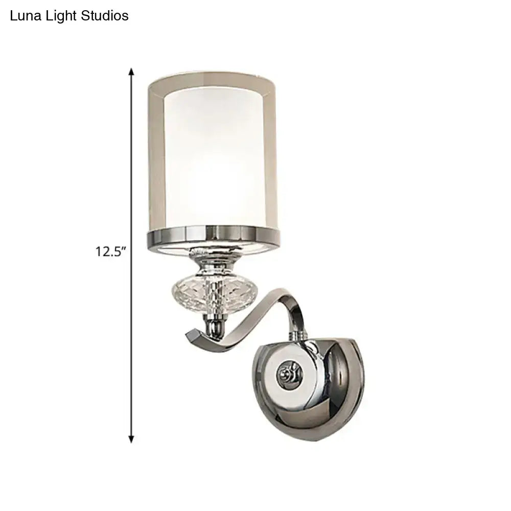 Modern chrome dual cylinder bathroom sconce with curvy arm featuring cylindrical frosted glass and crystal accent fixture height