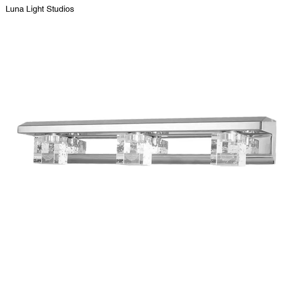 Modern chrome finish crystal cube vanity sconce with three clear crystal accents in warm white for bathroom use