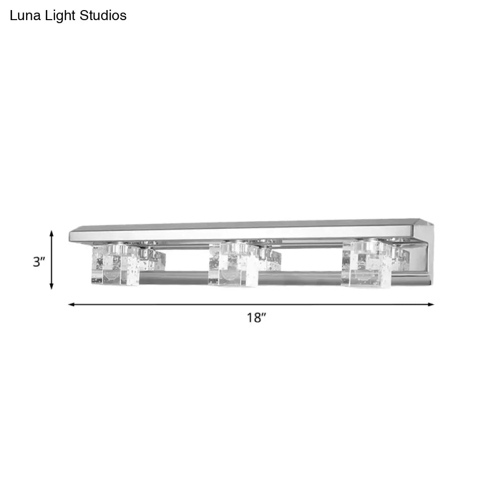 Modern chrome finish crystal cube vanity sconce with three clear crystal accents in warm white for bathroom use