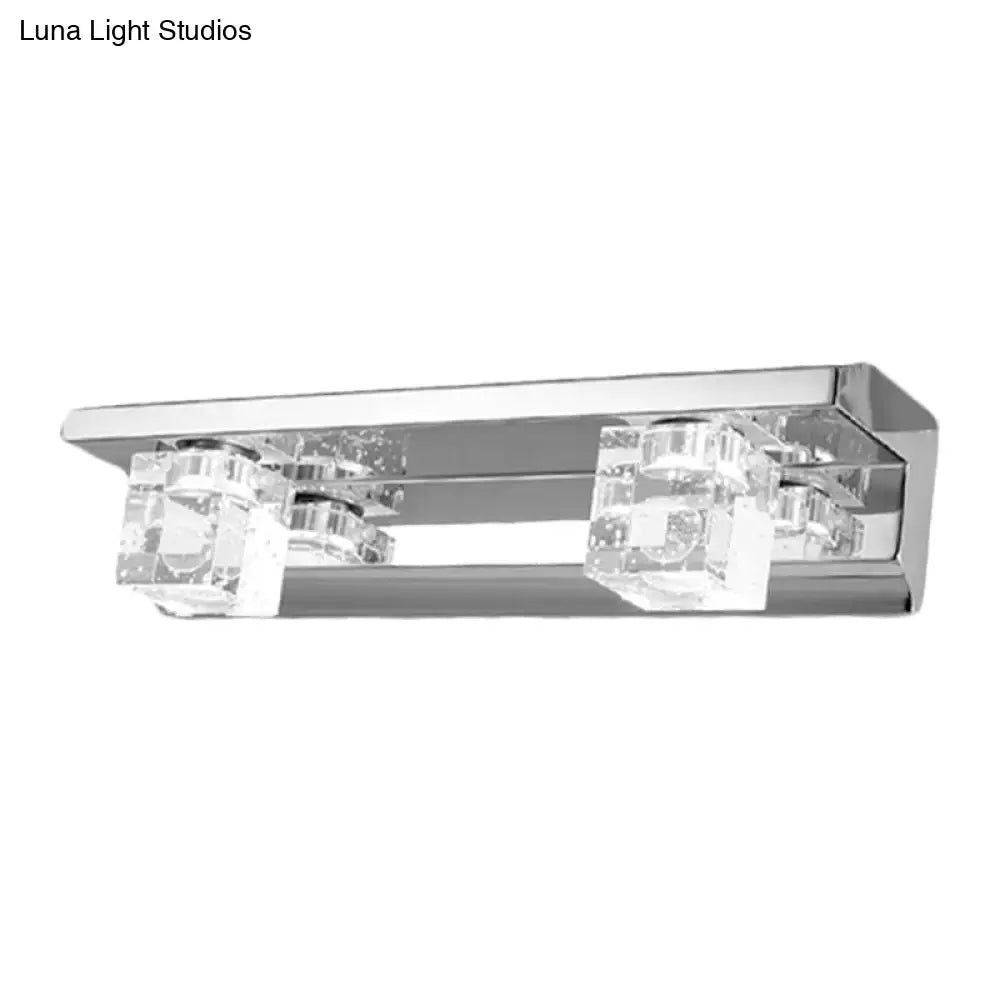 Modern chrome finish rectangular wall sconce with two clear crystal cube accents for warm white bathroom vanity lighting
