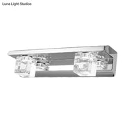 Modern chrome finish rectangular wall sconce with two clear crystal cube accents for warm white bathroom vanity lighting