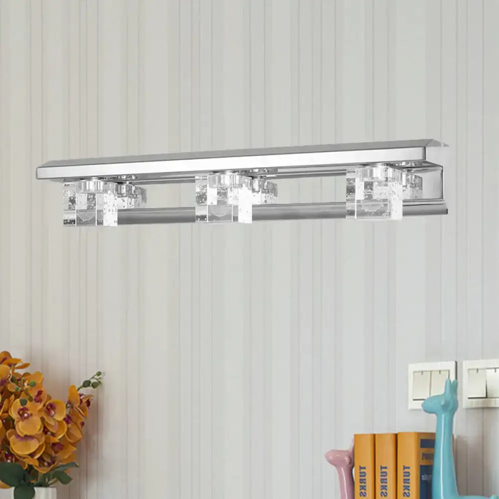 Modern chrome finish bathroom vanity light with three clear crystal accents and warm white illumination