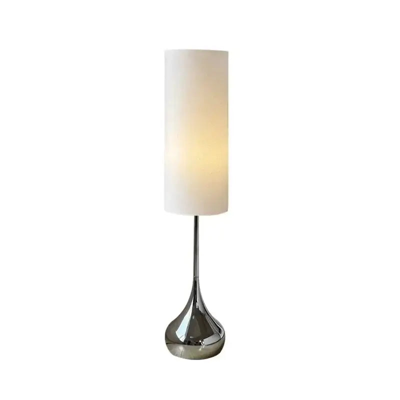 Modern chrome floor lamp with cream fabric shade designed for elegant living room decor by decorbites