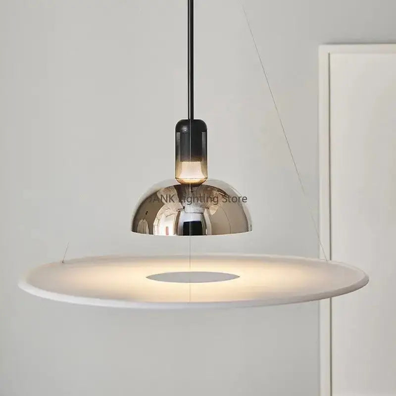 Modern chrome flying saucer chandelier with sleek chrome dome and white diffuser, suspended by black cord for living room lighting