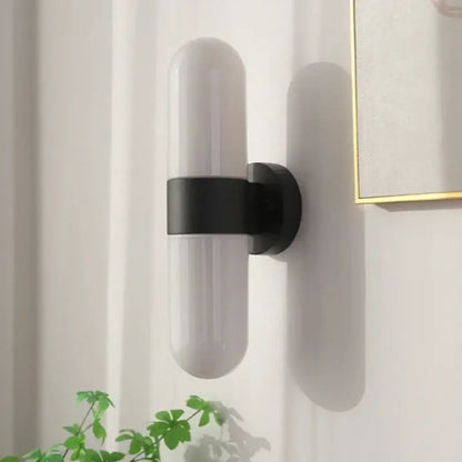 Modern chrome vanity mirror light with frosted glass shade and matte black metal bracket bathroom sconce