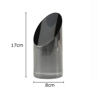 A sleek matte black 17cm tall cylindrical vase complements decorbites geometric crystal artwork polyhedron bookends