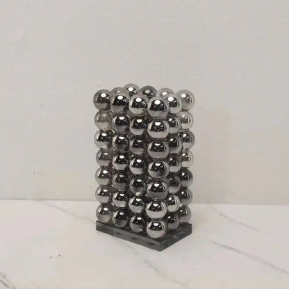 A sleek rectangular modern chrome geometric crystal ball tower made of 36 polished magnetic balls for living room decor