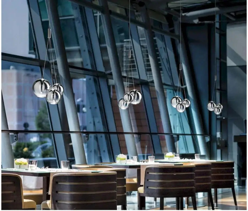 Modern chrome glass ball pendant light with spherical chrome finish hanging in clusters for dining room decorbites glass ball pendant