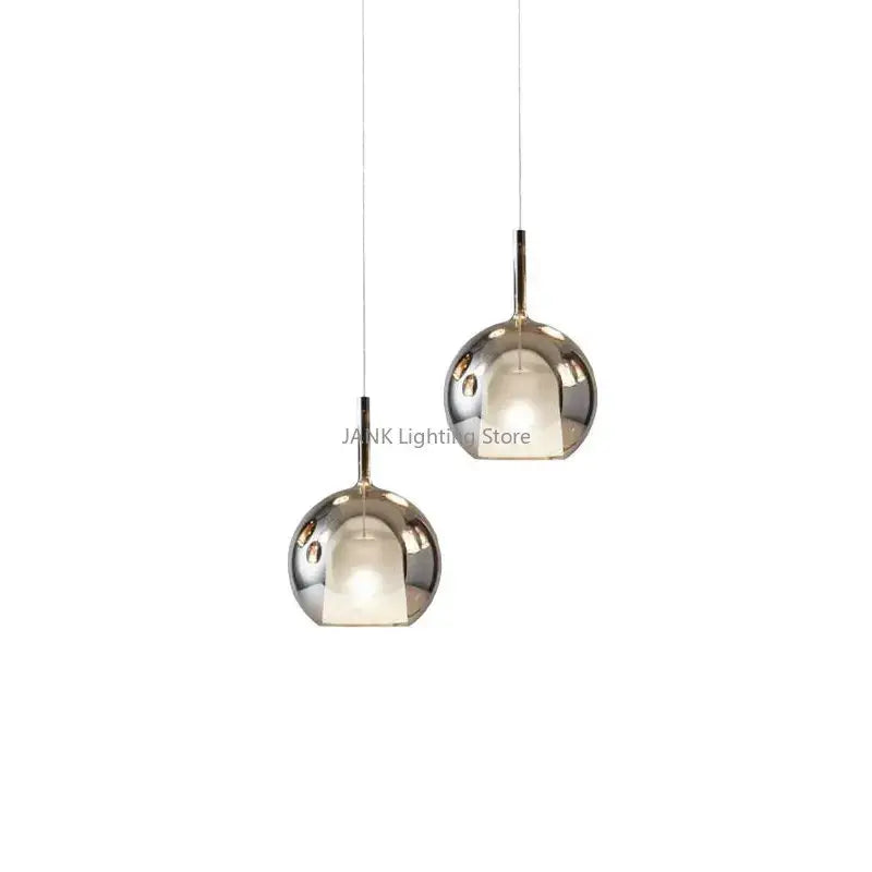Two sleek chrome glass bubble pendant lights with modern design ideal for dining room decorbites pendant lights
