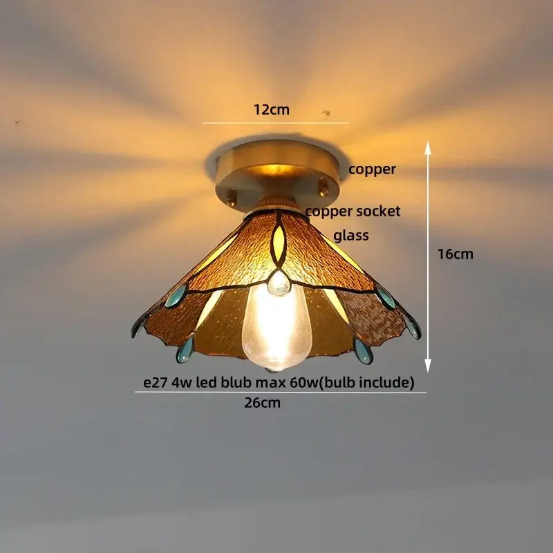 A warm-toned glass led ceiling light with amber panels teal edges and copper accents for bedroom use