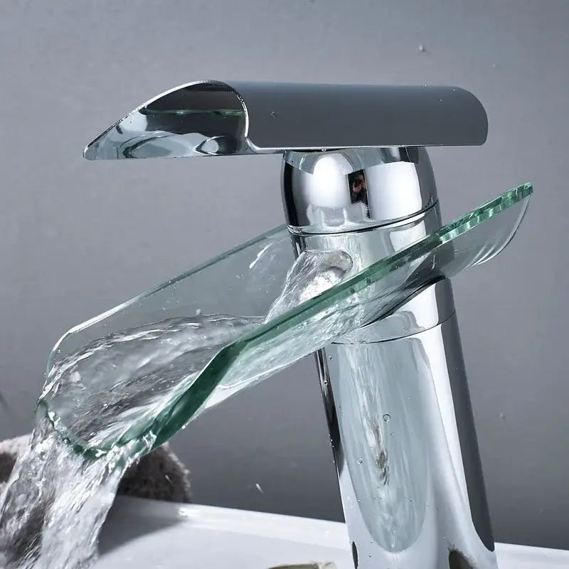 Modern chrome glass spout basin faucet with transparent glass spout and handle waterfall design for bathroom use