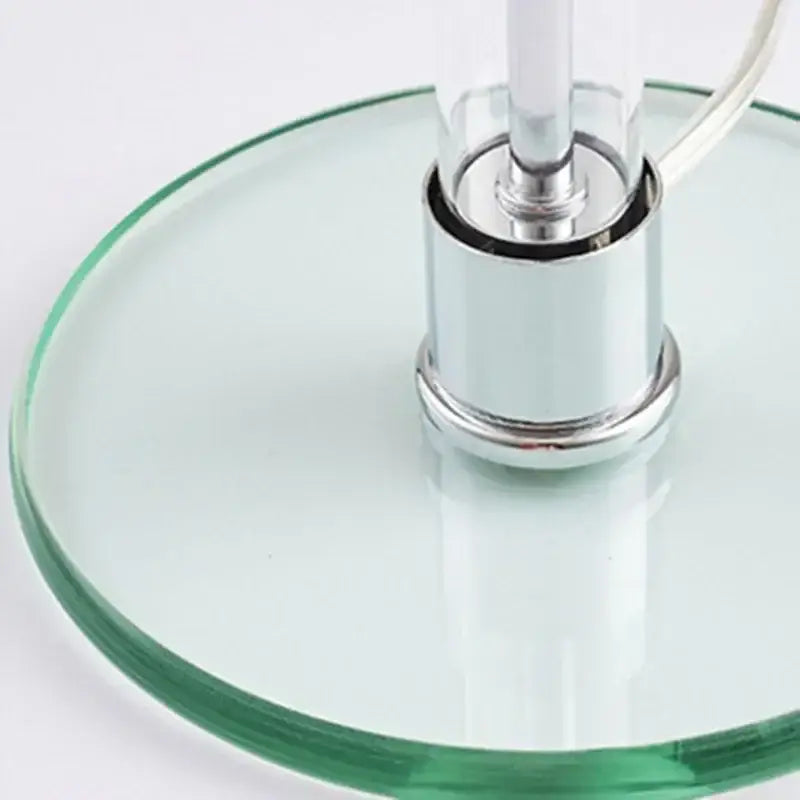 Modern chrome glass table lamp with clear glass base, polished chrome column, and visible power cord for bedroom decorbites glass table lamp