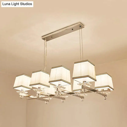 Modern chrome island pendant light with five cream fabric shades and metal arms ideal for dining rooms island pendant light kit