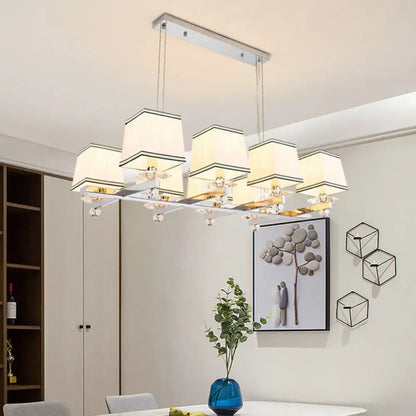 Modern chrome island pendant light with six cream shades and gold-toned fixtures ideal as an island pendant light kit