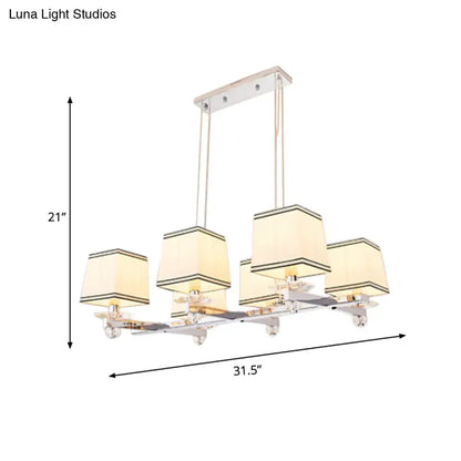 Modern chrome island pendant light with five cream square shades and black trim for dining rooms pendant light kit