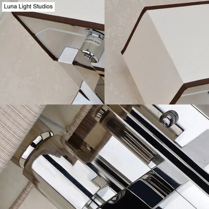 Modern chrome led wall sconce lighting with sleek geometric design and white fabric shade accented by dark brown trim