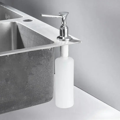 Modern chrome liquid soap dispenser with sleek cylindrical white plastic bottle and lever-style pump for kitchen use
