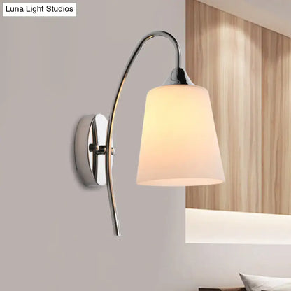 Modern chrome milky glass trumpet wall sconce with curved arm and frosted shade for stairway lighting