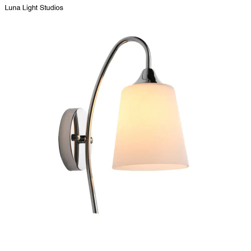 Modern chrome trumpet wall sconce with curved arm and warm milky glass shade for stairway lighting