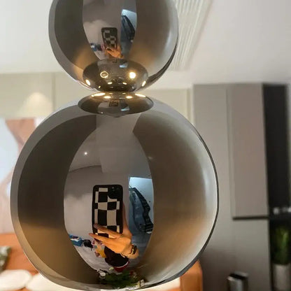 Modern chrome multi ball pendant light source featuring shiny chrome spherical double orb design for bedroom use