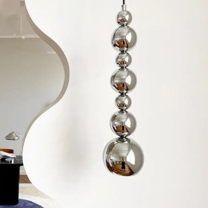 Modern chrome multi ball pendant light source with polished chrome spheres stacked vertically for bedroom hanging lamp