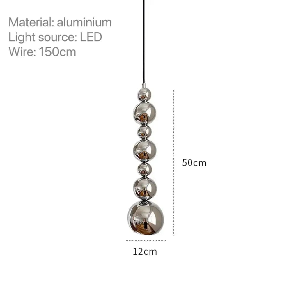 A modern chrome multi ball pendant light features five polished aluminum spheres on an led wire light source