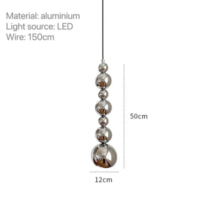 A modern chrome multi ball pendant light features five polished aluminum spheres on an led wire light source