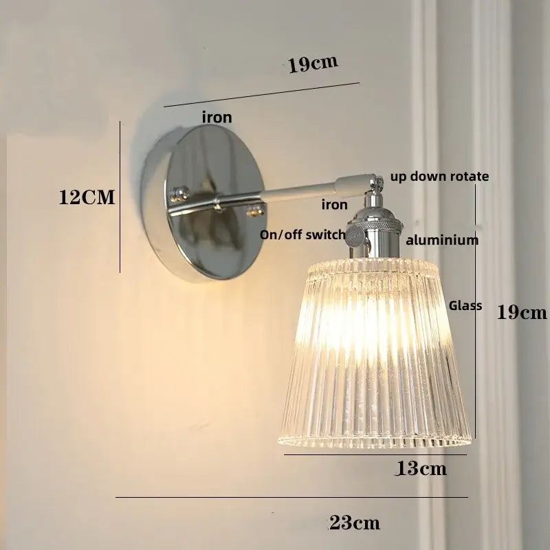 A sleek modern chrome wall lamp with clear glass ribbed shade and polished iron base for dining room decorbites clear glass