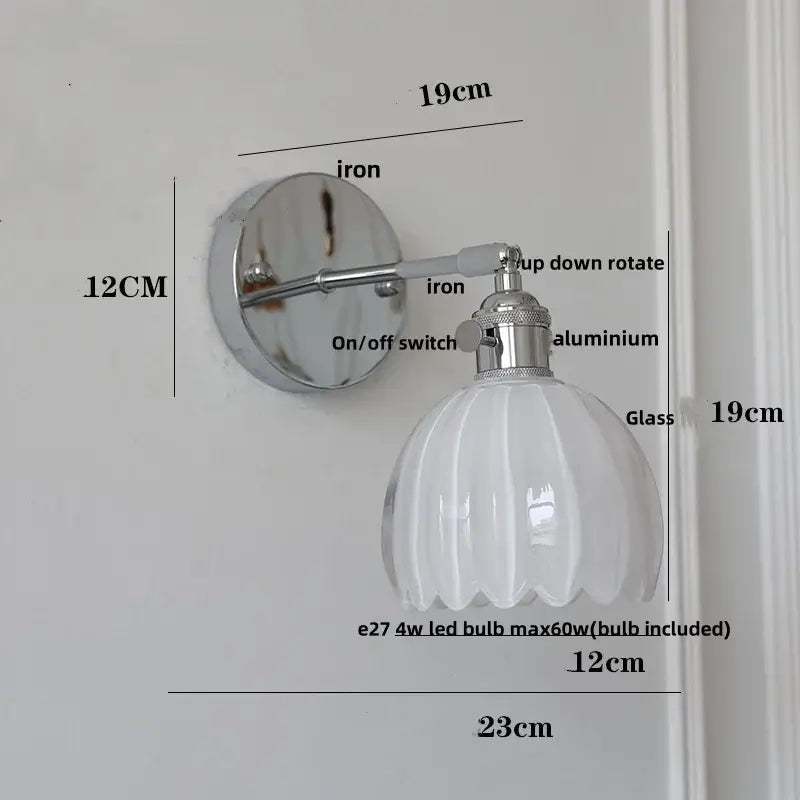 A modern chrome wall lamp with a polished iron base and white ribbed clear glass shade for dining room decorbites clear glass