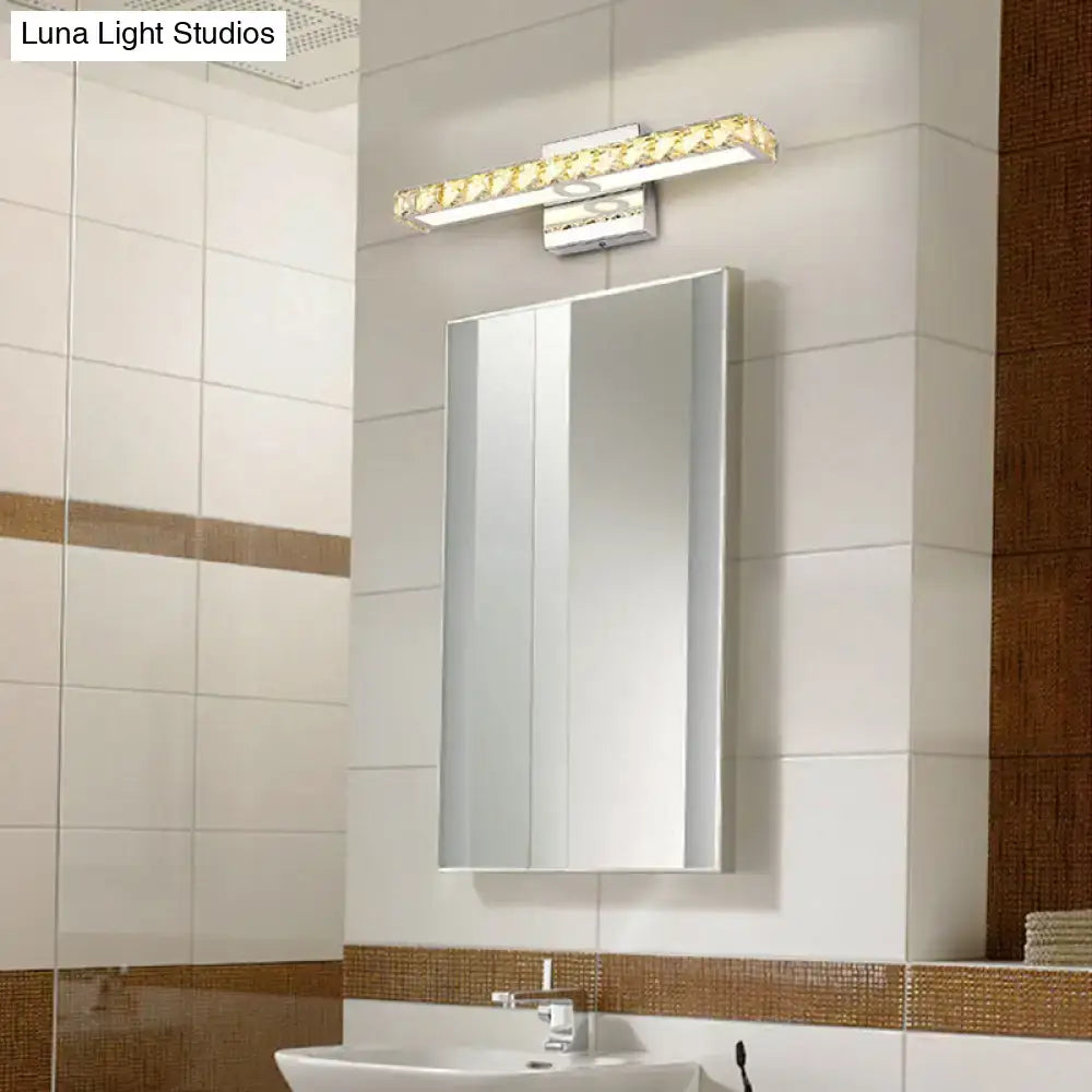 Modern chrome and silver champagne linear wall sconce with sleek rectangular design and crystal accents for bathroom use