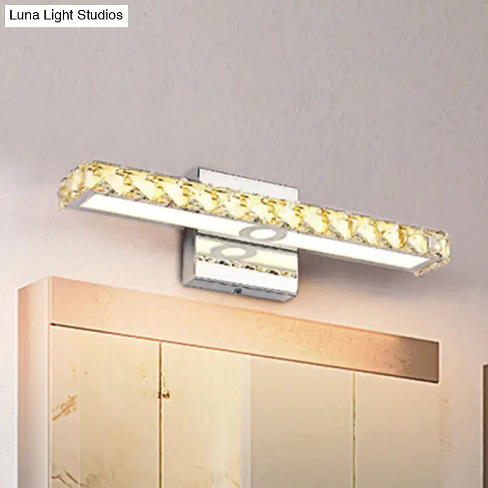 Modern chrome and silver champagne linear wall sconce with a sleek rectangular design and golden crystal accents