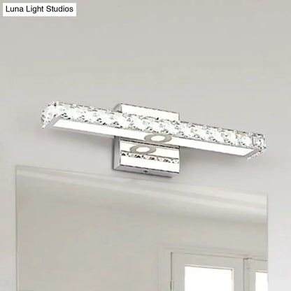 Modern chrome and silver champagne linear wall sconce with embedded clear crystals for bathroom lighting