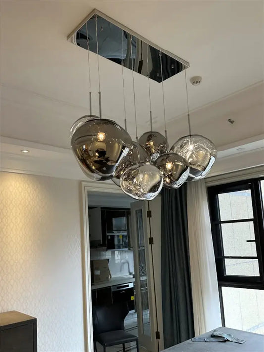 Modern chrome spherical acrylic pendant light with reflective glass globes and cord pendant installation for dining room