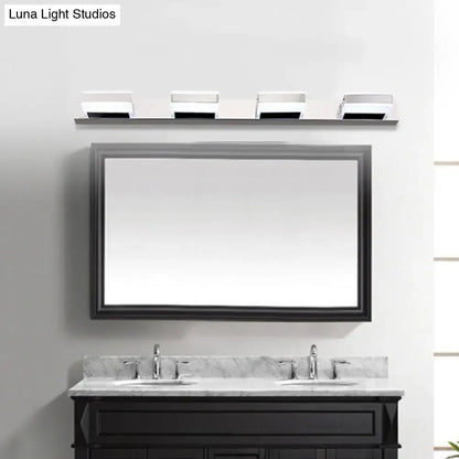 Modern chrome square acrylic vanity light fixture height above black-framed rectangular bathroom mirror and double-sink vanity