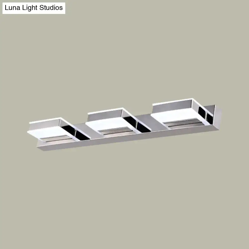 Modern chrome square acrylic vanity light fixture with three rectangular led panels and black accents highlighting fixture height