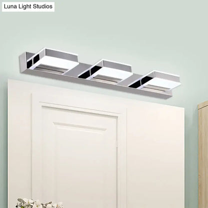Modern chrome square acrylic vanity light with three rectangular panels and black accents emphasizing fixture height
