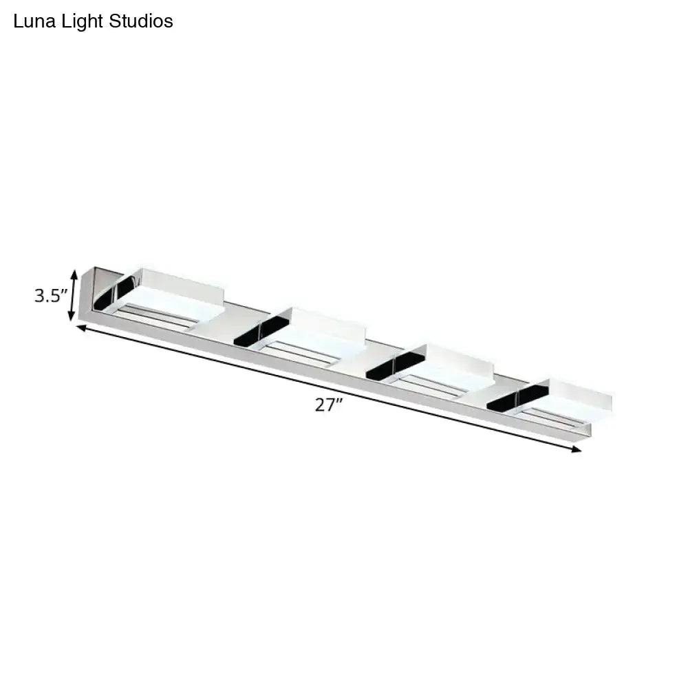 Modern chrome square acrylic vanity light fixture with four white diffusers and black accents emphasizing fixture height