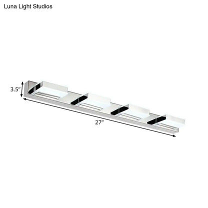 Modern chrome square acrylic vanity light fixture with four white diffusers and black accents emphasizing fixture height