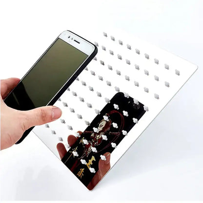 Modern chrome square rainfall shower head with white magnetic phone holder featuring evenly spaced silver-toned studs