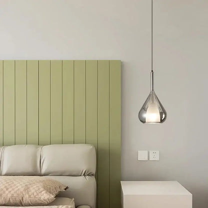 A sleek modern chrome teardrop chandelier pendant light with polished finish hanging suitable for dining room