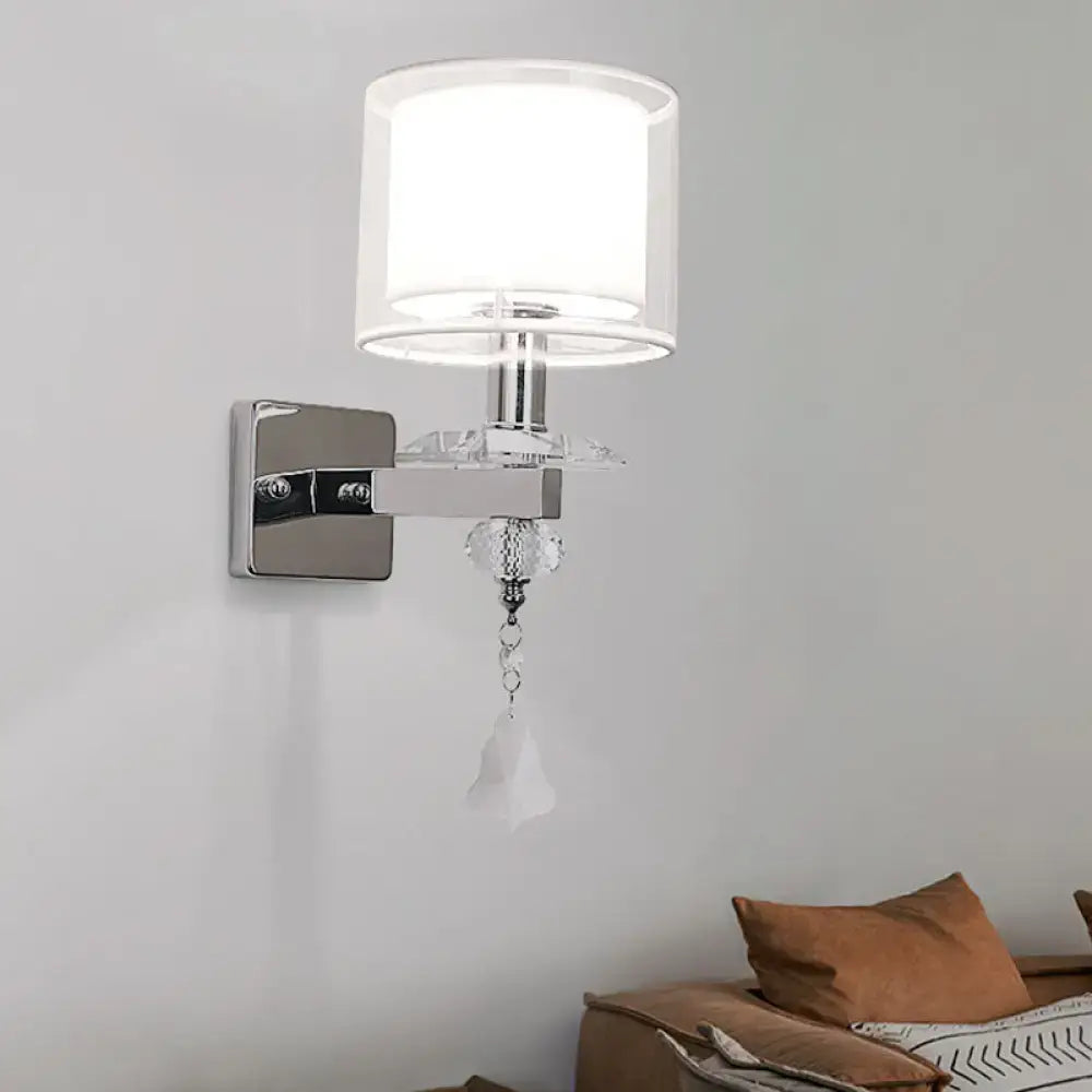 Modern chrome wall lamp with cylindrical white fabric shade and crystal accent for bedroom glass sconce lighting
