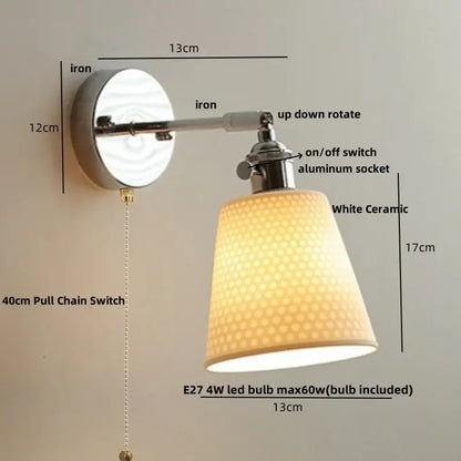 Modern chrome wall light with a sleek white decorbites ceramic led perforated fabric shade on an iron arm and base