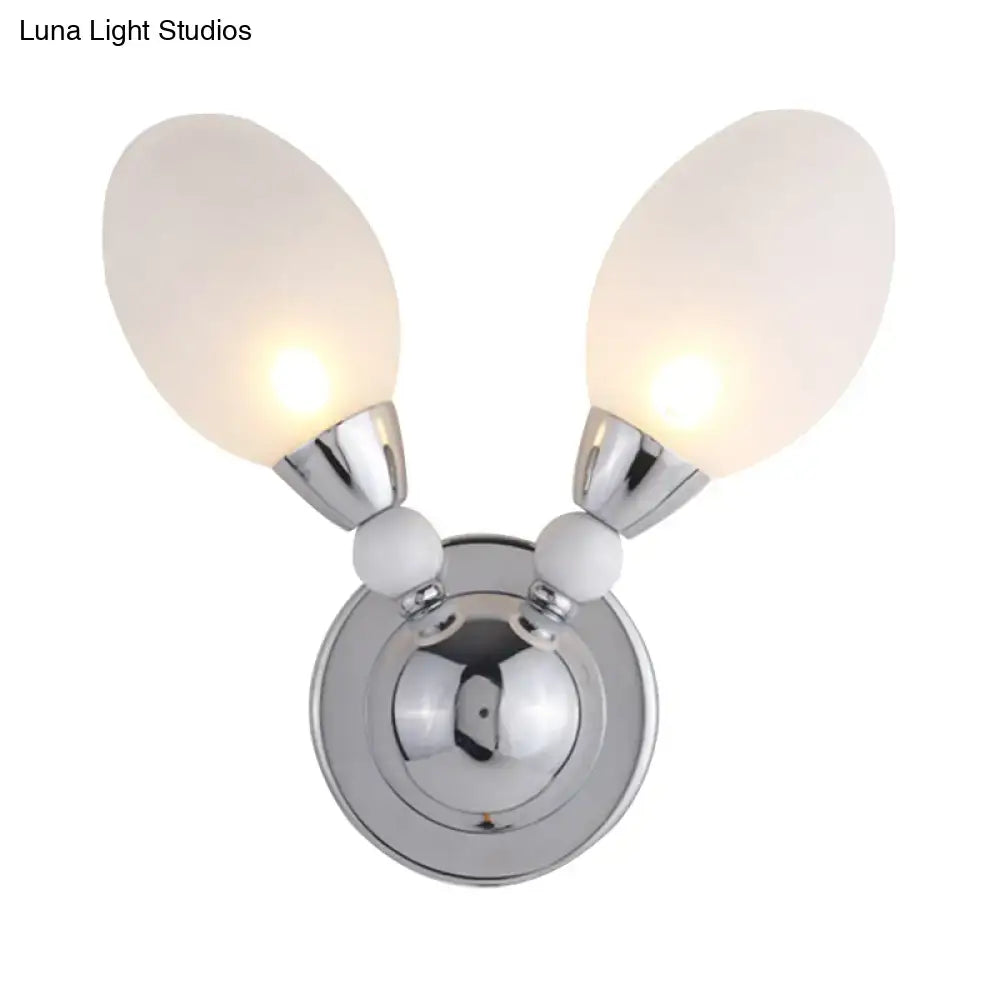 Modern chrome wall light featuring white glass shades with frosted globes and decorative white spheres for bedroom use