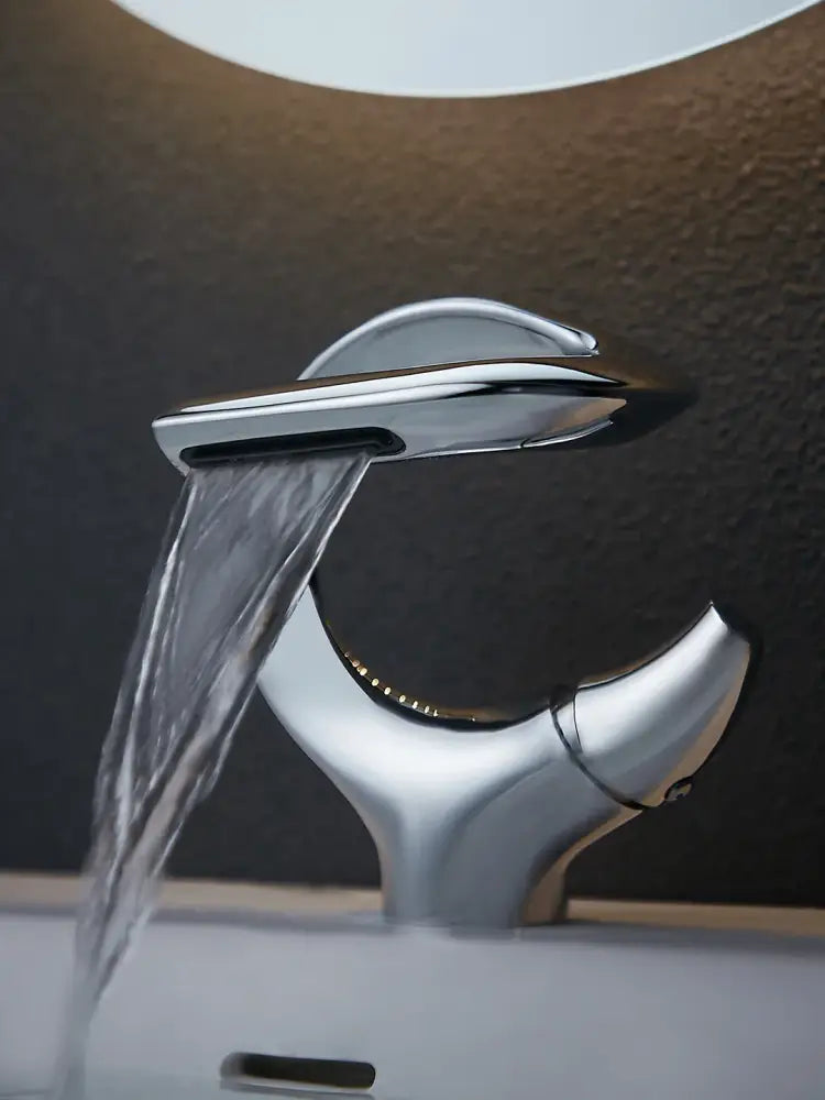 Modern chrome waterfall single handle bathroom faucet with sleek sculptural design for single hole installation