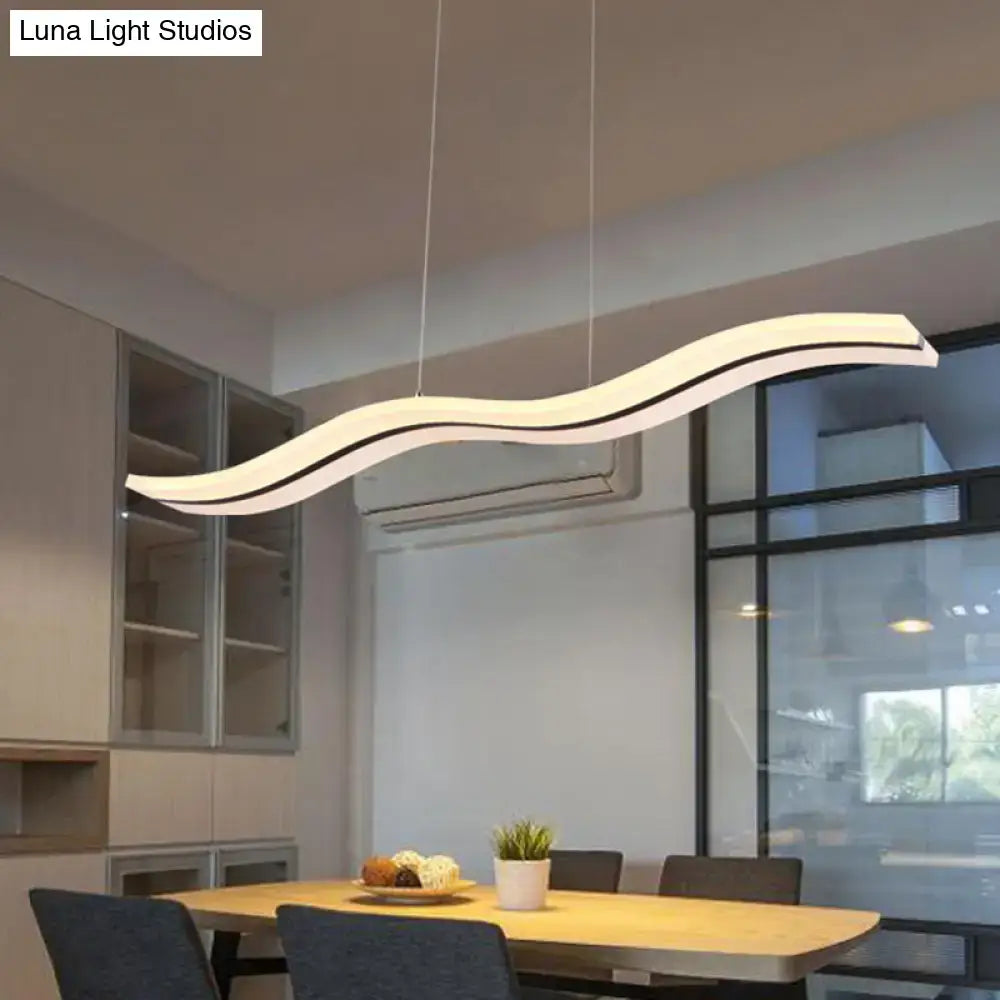 Modern chrome wave led island lighting fixture featuring a white led pendant light with sleek wavy design and black trim