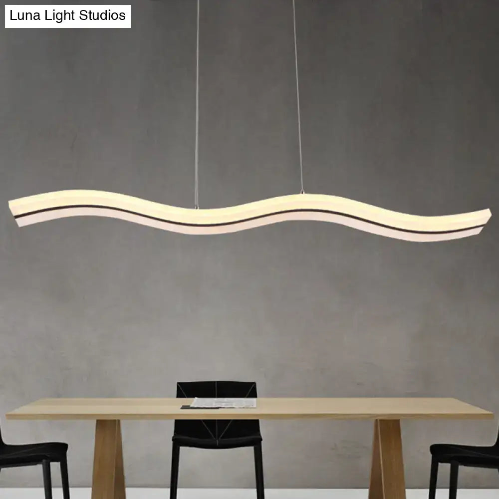Modern chrome wave island lighting fixture with sleek minimalist design and warm white layered led bands suspended by cables