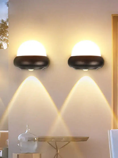 Two sleek black modern circular solar led wall lights with warm diffused light for garden exterior decorbites led wall use