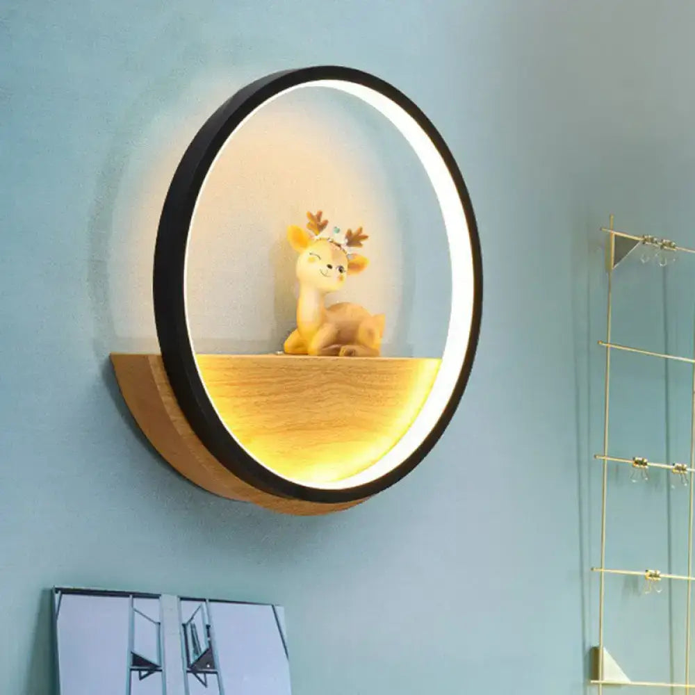 Modern circular black wall light with warm led glow and wooden shelf featuring a decorative deer figurine for living room